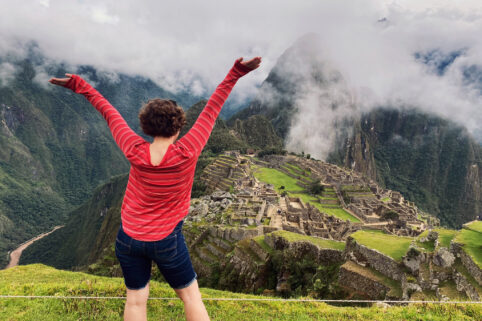 Student in Peru looking out over the foggy mountains