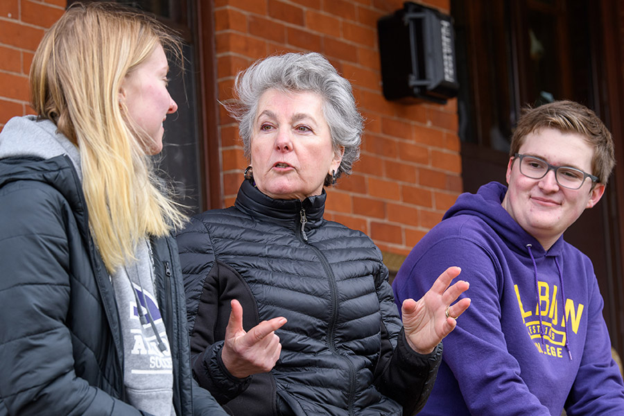 Joey Miller, '75, chair of the Albion College Board of Trustees, with Albion students, March 2022.