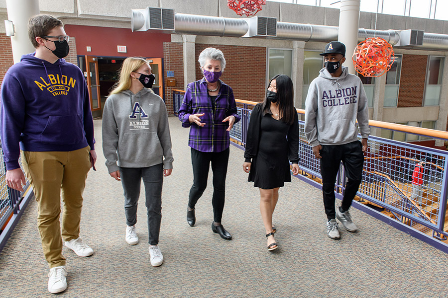 Joey Miller, '75, chair of the Albion College Board of Trustees, with Albion students, March 2022.
