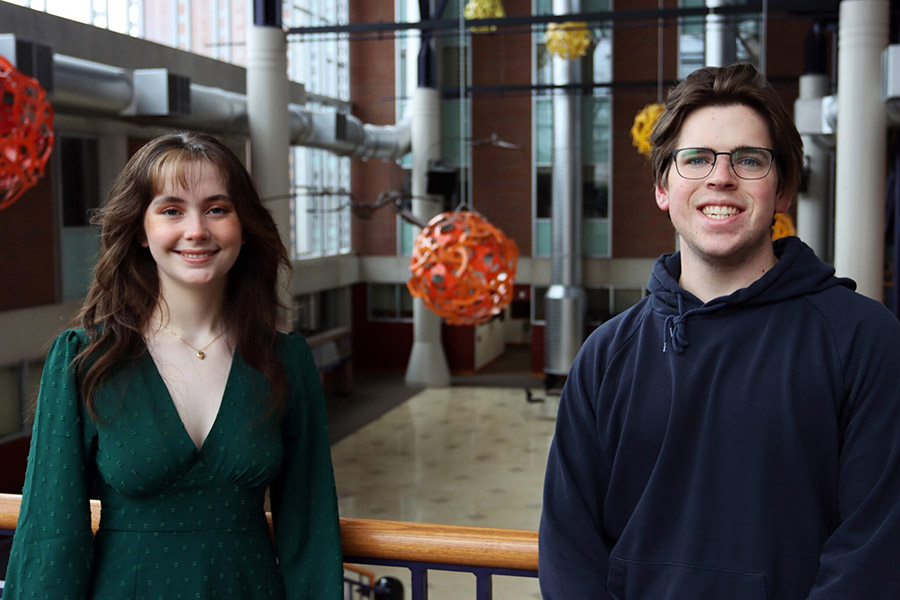 Two students standing in the science atrium.
