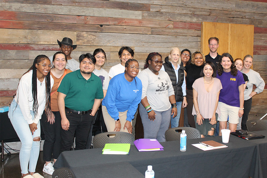 Albion College students posing with Reverend Faith Fowler