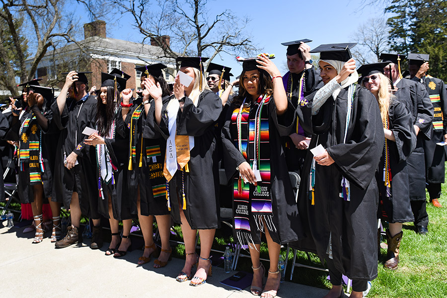 Albion College Class of 2022 members move tassels from right to left on their caps.