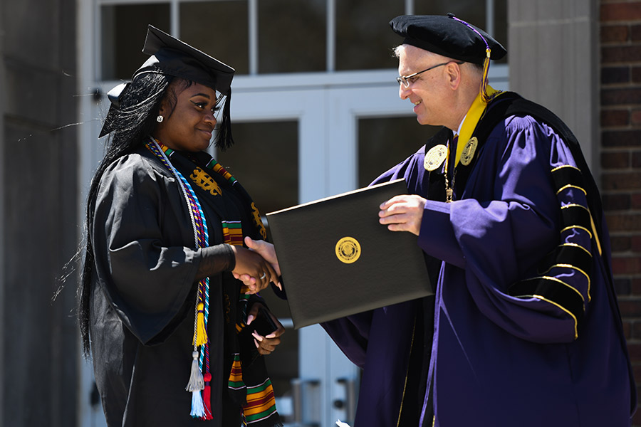 Albion College Interim President Joe Calvaruso (right) and a newly graduated 2022 senior.