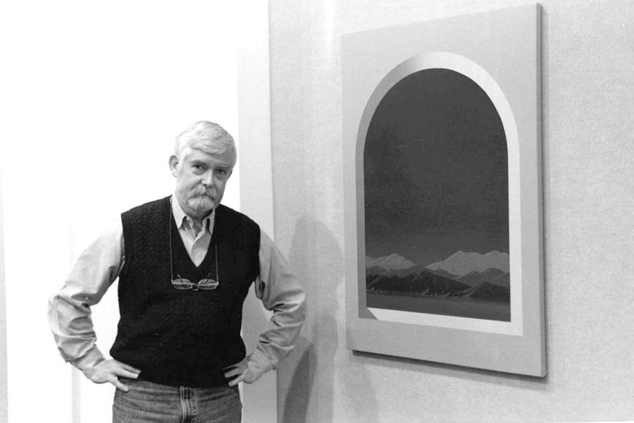 Ralph Davis standing next to a painting of a window with mountains in the distance.
